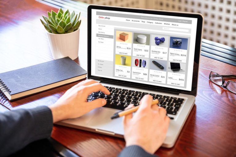 Man working with a computer laptop to improve ecommerce SEO.